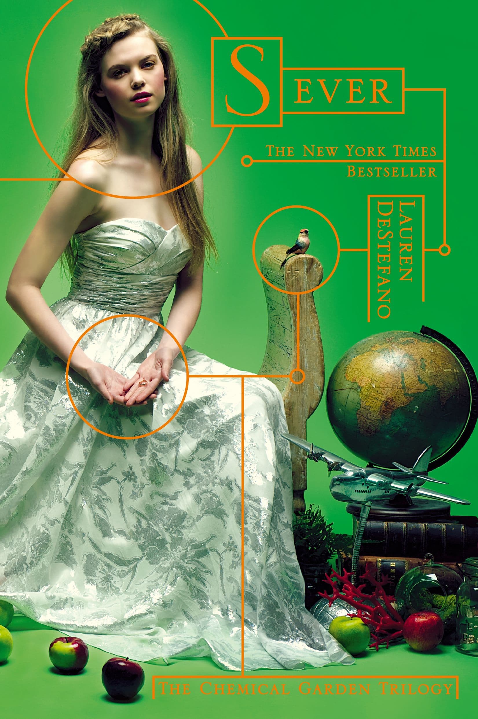 Girl sitting against acid green backdrop with globe at her feet